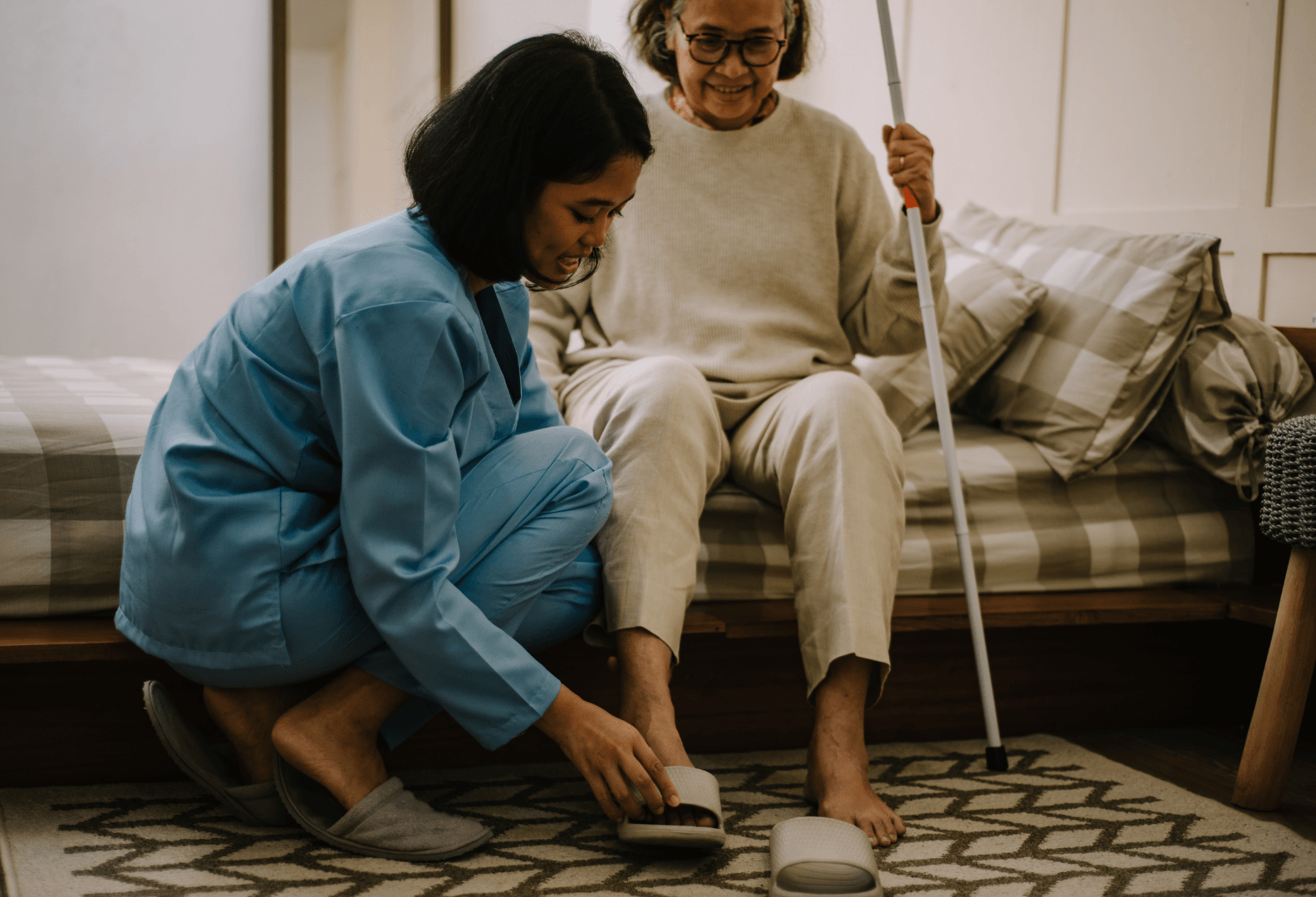 Caregiver assisting an elderly woman